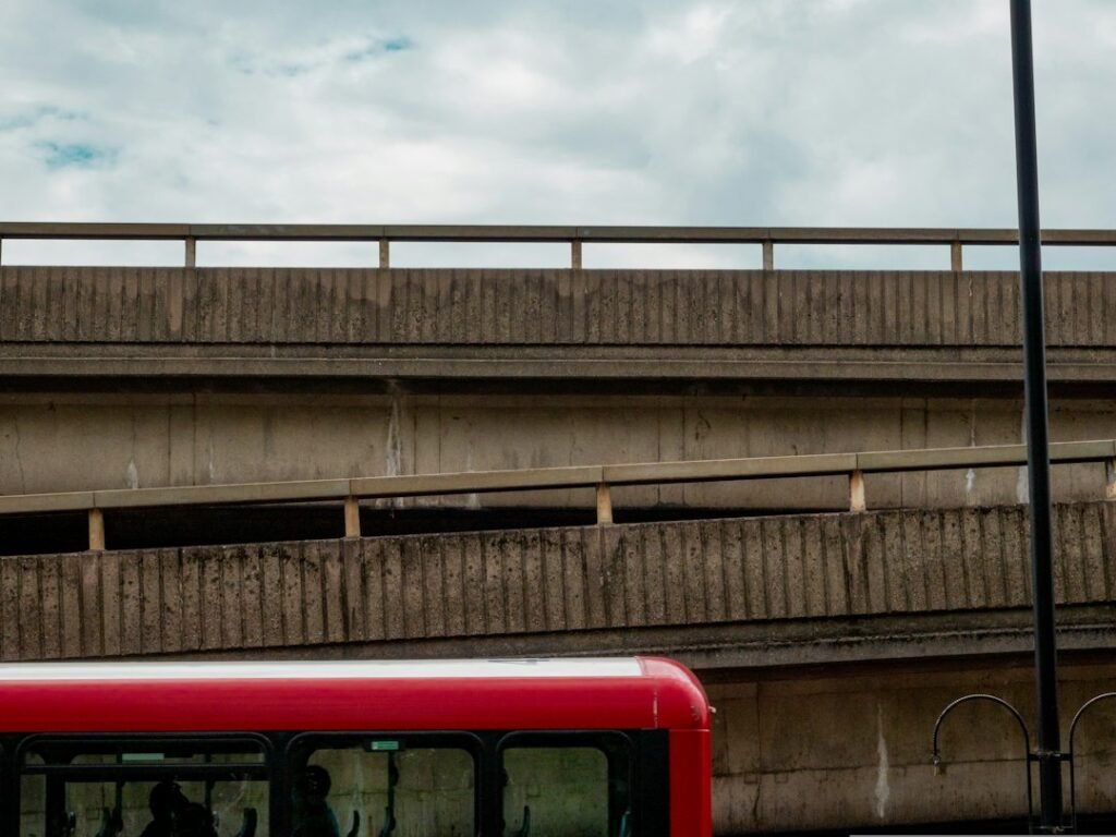 Bus on a road beside a bridge for the Bus Masters India APK download guide