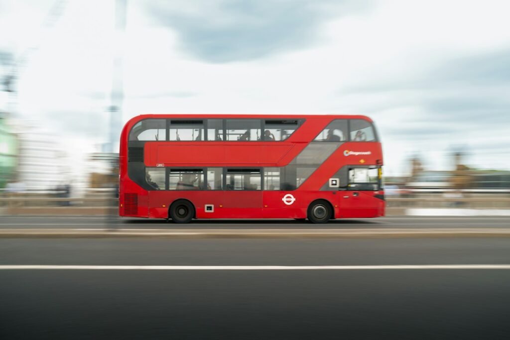 Red city bus driving on a road