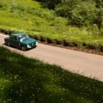 Car on a hilly road illustrating off-road racing