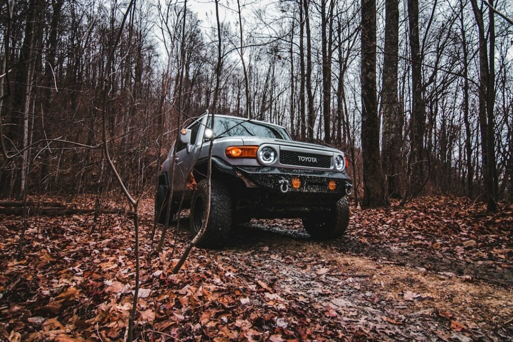 Four-wheel-drive truck on a rugged forest trail illustrating off-road simulation