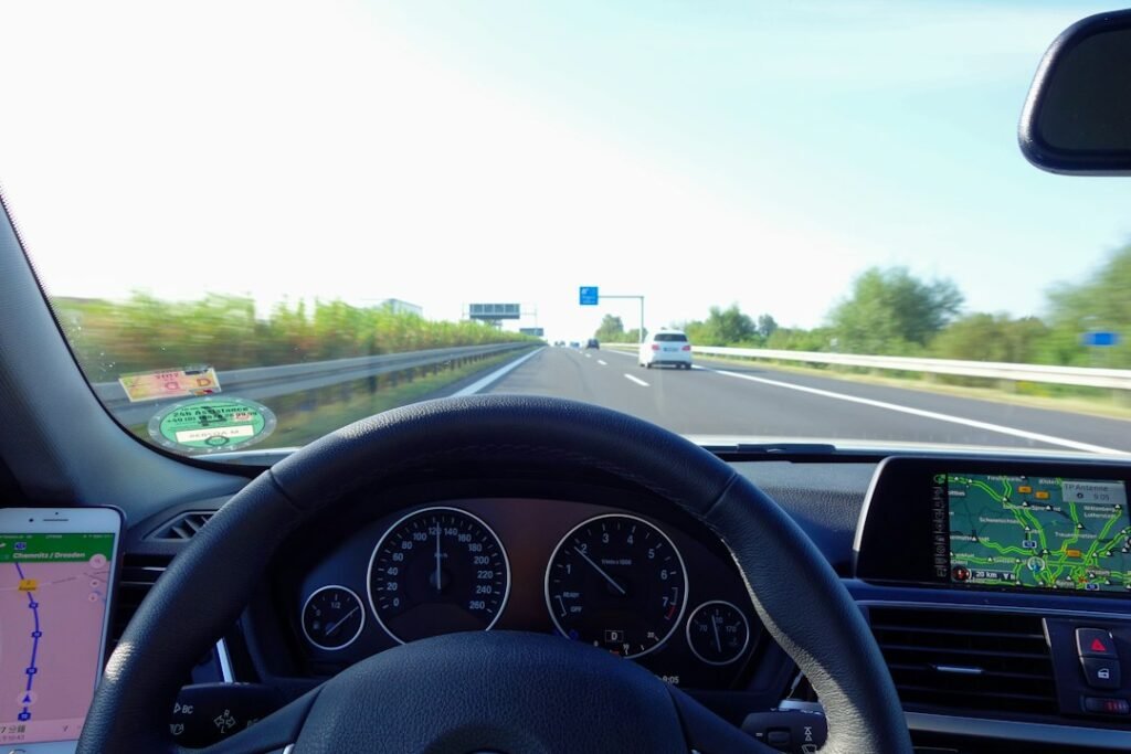 View from inside a car on a highway, illustrative image for Real Driving School