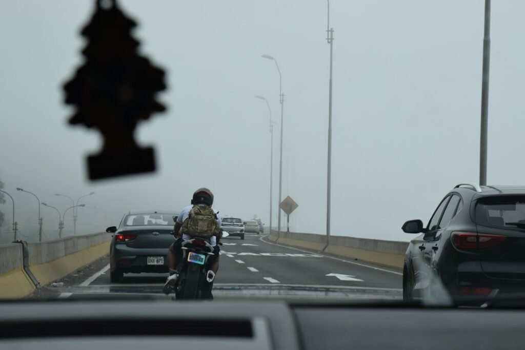Motorcyclist on a road with traffic illustrating a motorcycle riding game