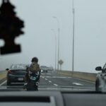 Motorcyclist on a road with traffic illustrating a motorcycle riding game
